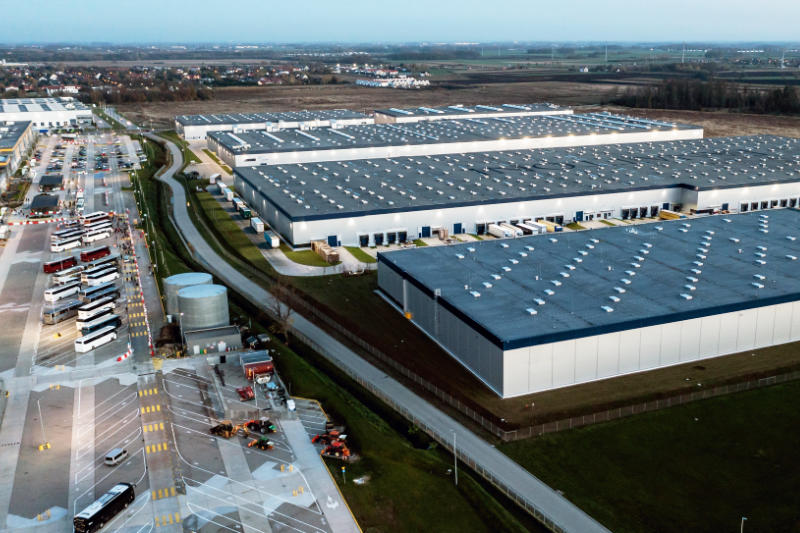 Top view of warehouses, aerial view of large logistics warehouses in the evening
